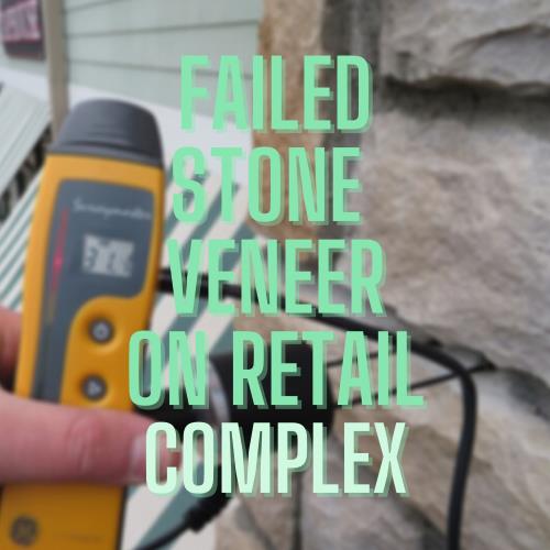 Failed stone veneer on shopping center